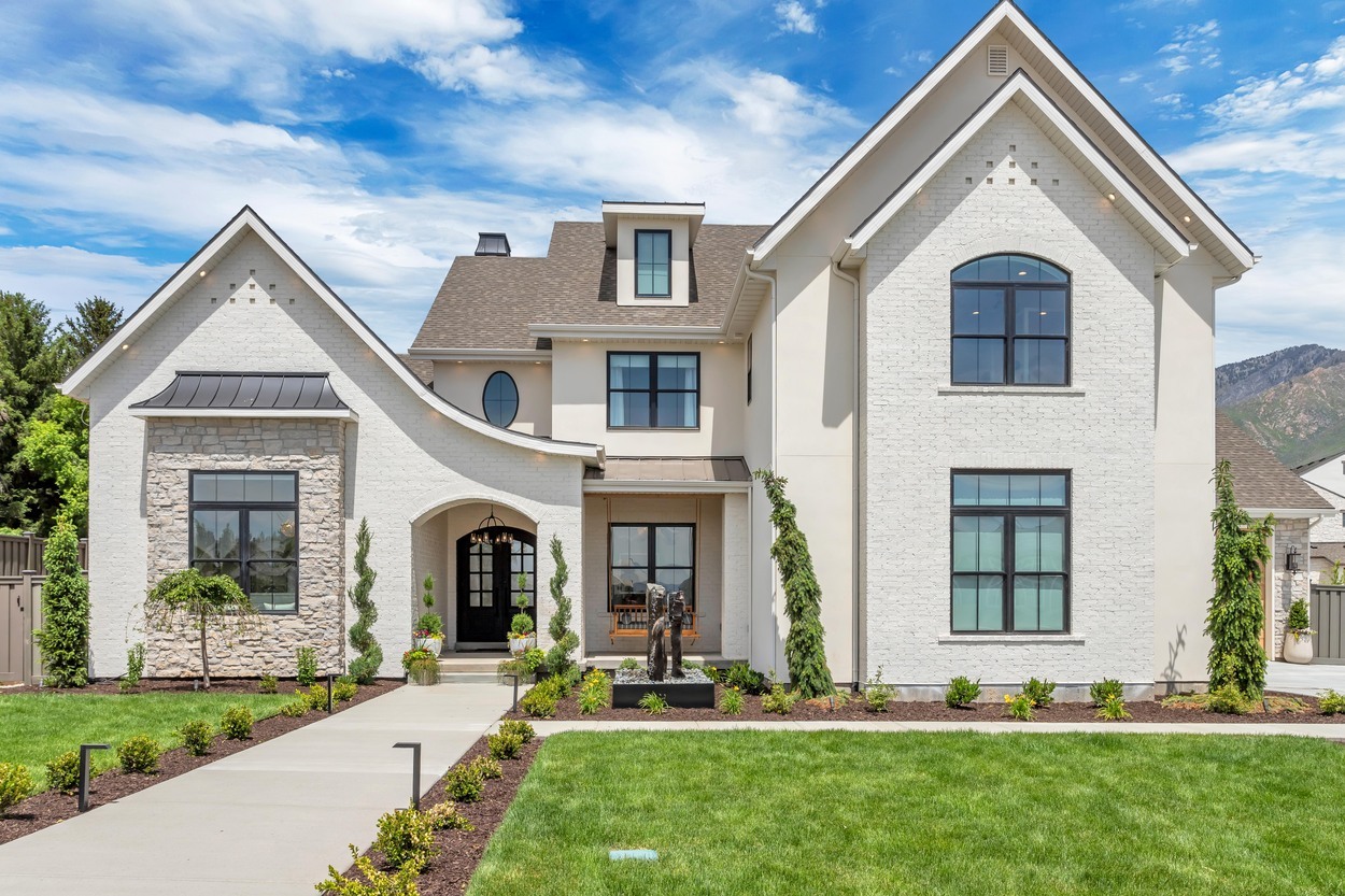 Front view of Alpine Swoop custom home with modern windows and landscaped entry, 2020 Utah Valley Parade of Homes Front view of Alpine Swoop custom home with modern windows and landscaped entry, 2020 Utah Valley Parade of Homes