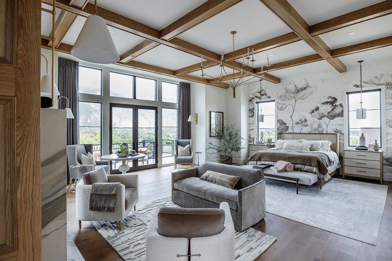 Primary suite with exposed beam ceiling in custom home by E Builders