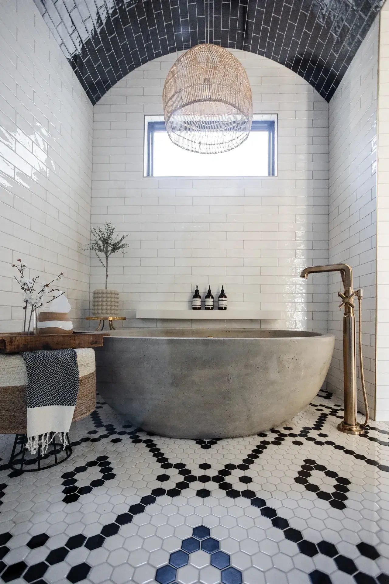 Freestanding bathtub in floor to ceiling tiled bathroom in custom home in Utah by E Builders