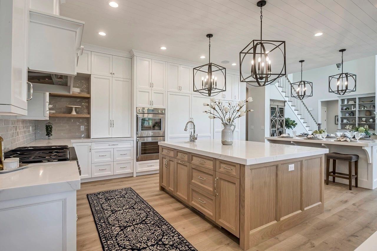 Bright and open kitchen layout with pendant lighting in a custom home by E Builders featured in the 2019 Utah Valley Parade of Homes