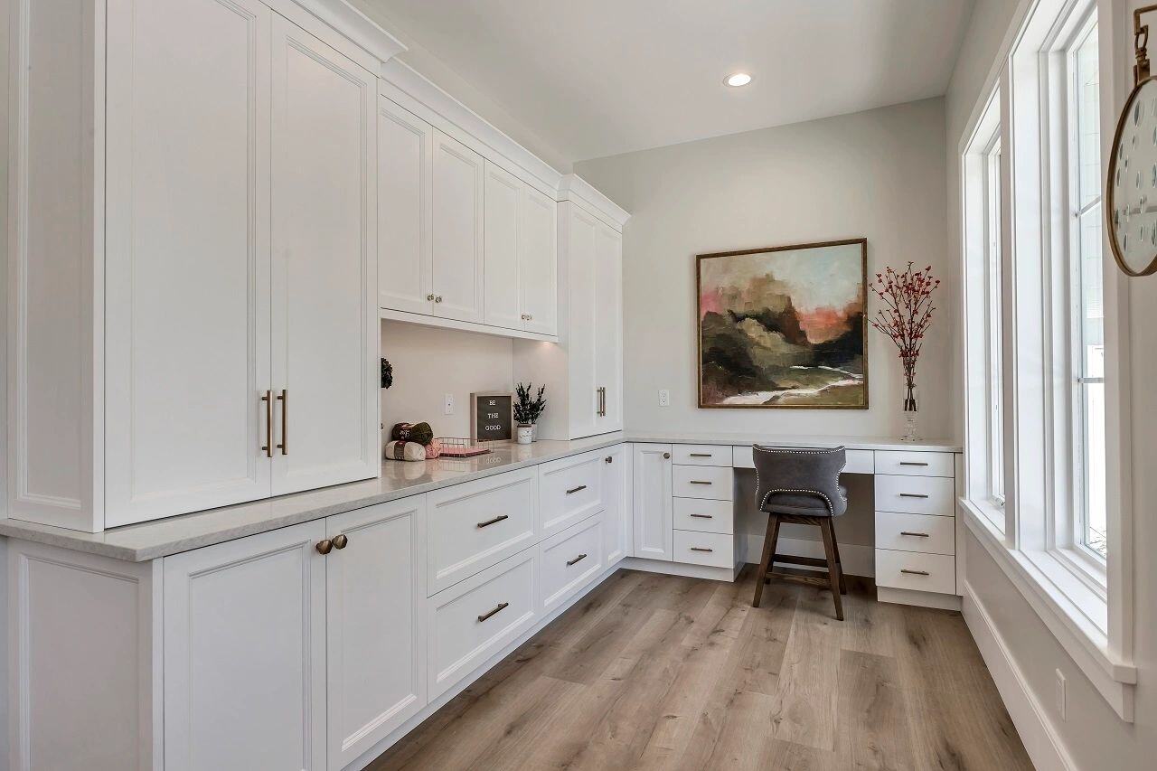 Feminine workspace with ample storage and window views in a custom home by E Builders featured in the 2019 Utah Valley Parade of Homes