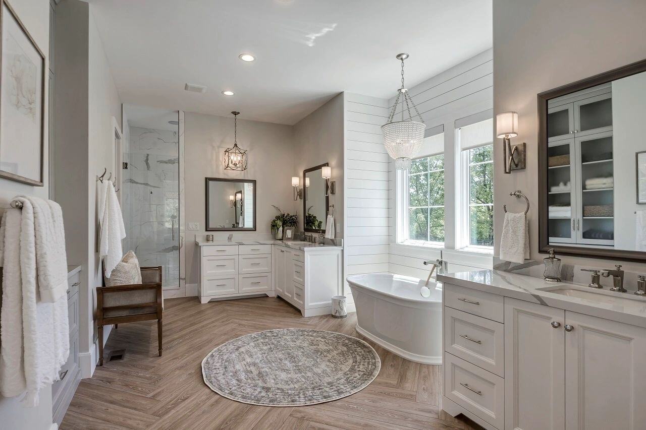 Luxurious master bathroom with soaking tub and dual vanities in a custom home by E Builders featured in the 2019 Utah Valley Parade of Homes