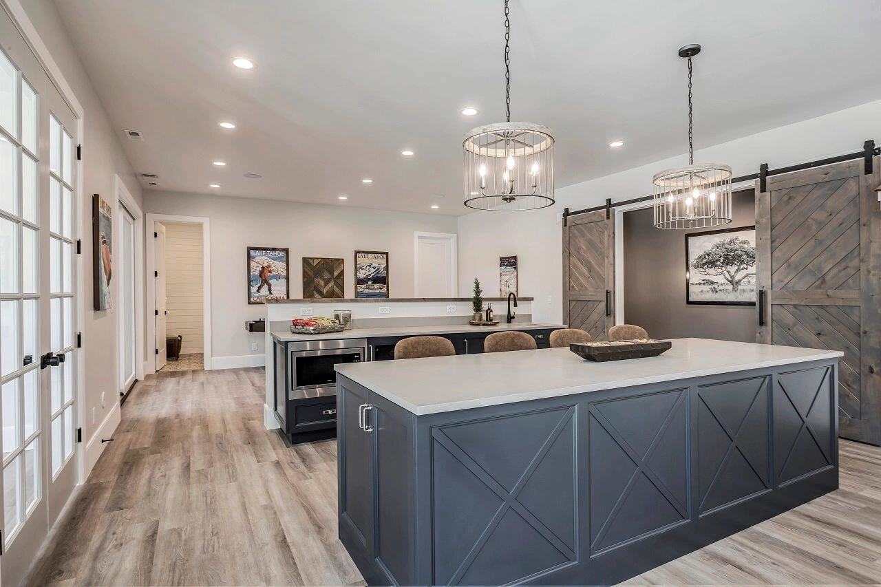 Spacious basement kitchen with island seating in a custom home by E Builders featured in the 2019 Utah Valley Parade of Homes