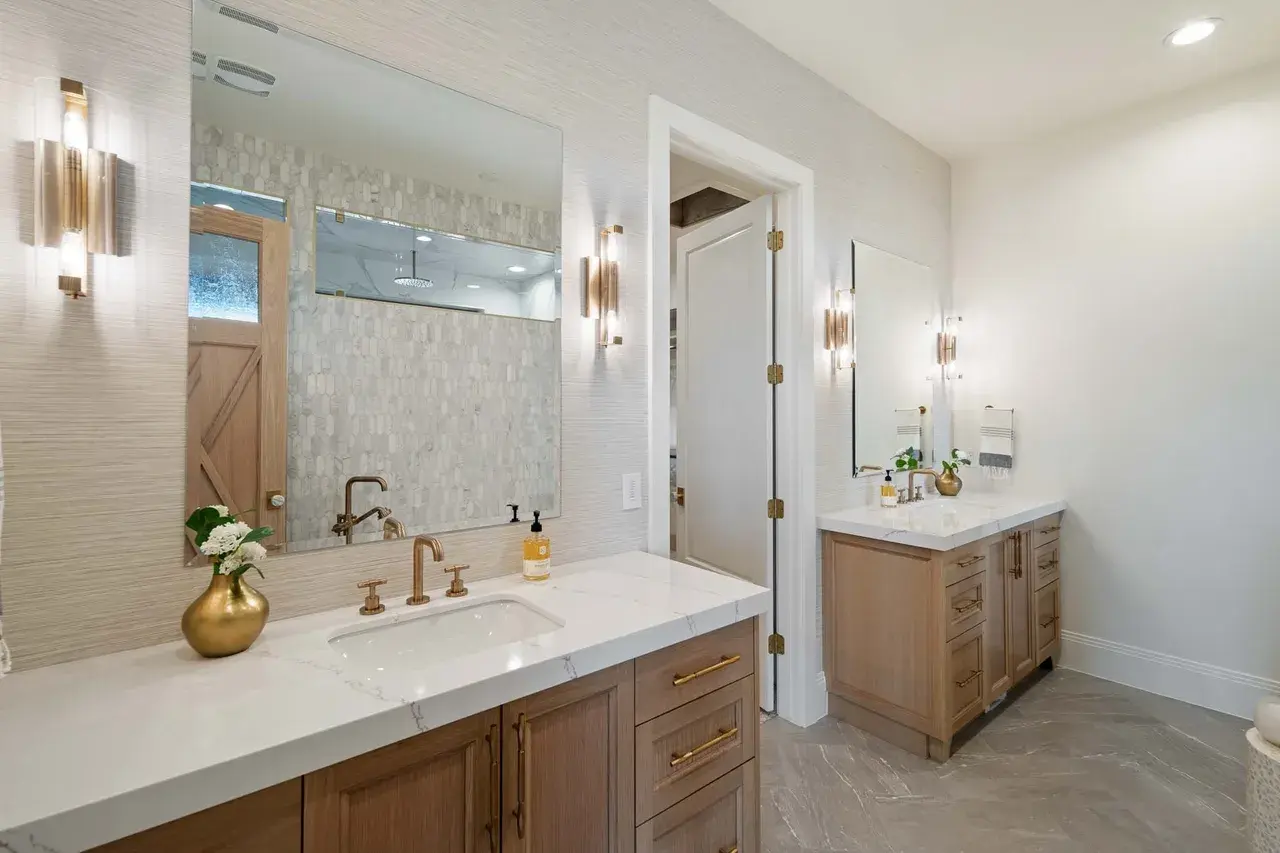 Dual vanity master bath with gold fixtures in a custom home in Utah Valley by E Builders