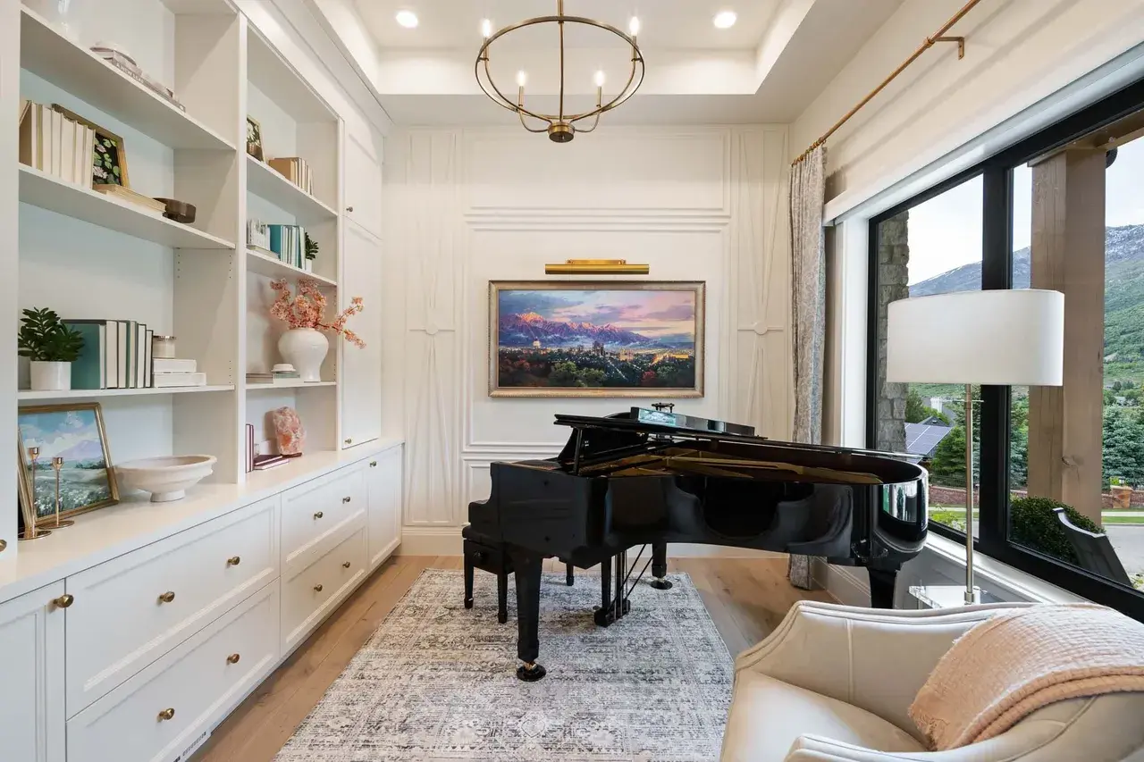 Elegant music room with grand piano in a custom home in Utah Valley by E Builders