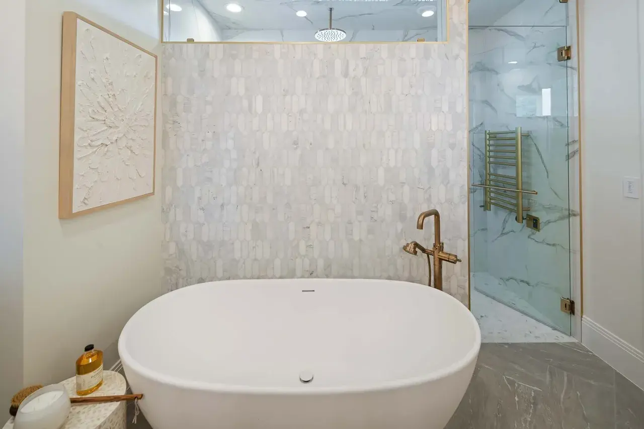 Freestanding tub and marble shower in a custom home in Utah Valley by E Builders