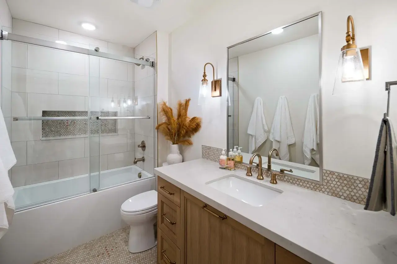 Guest bathroom with soaking tub and glass shower in a custom home in Utah Valley by E Builders