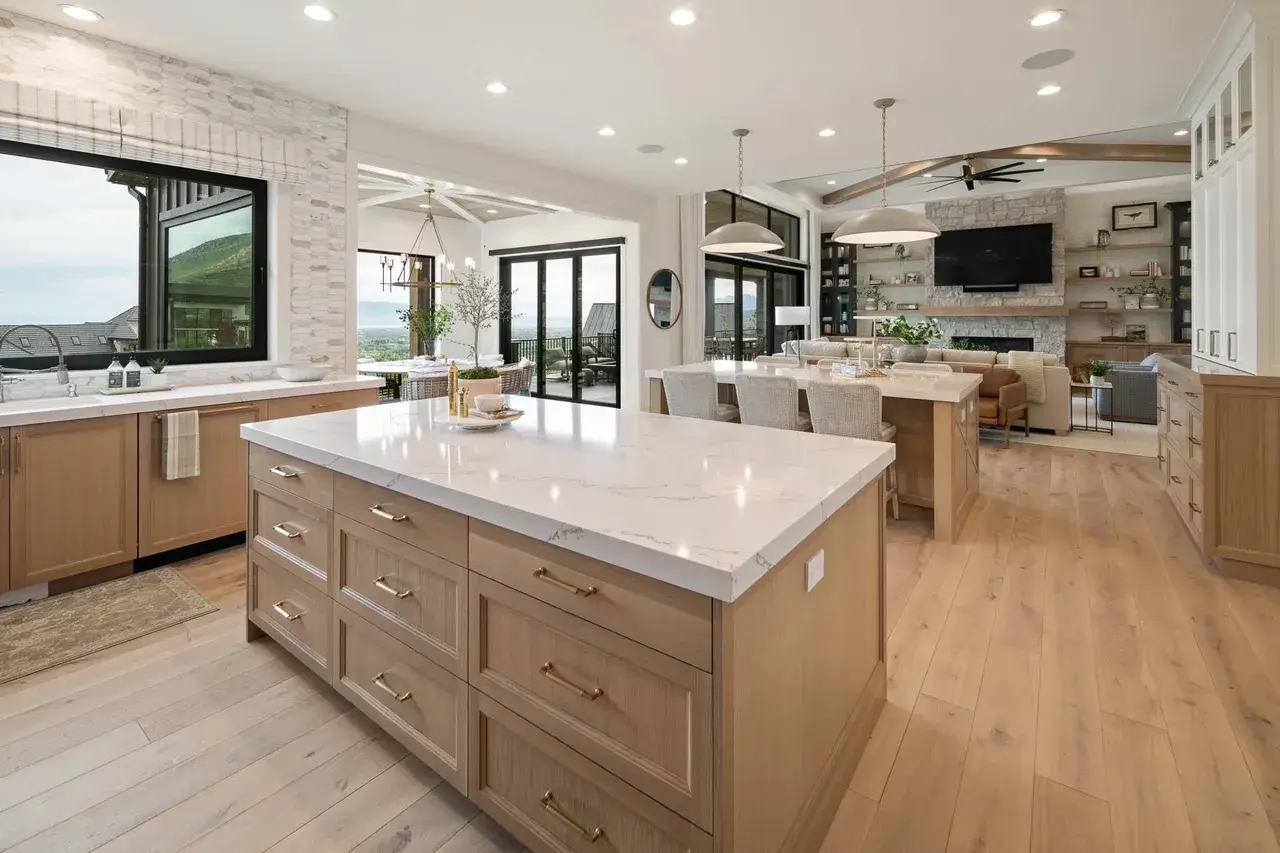 Open kitchen layout flowing into great room in a custom home in Utah Valley by E Builders