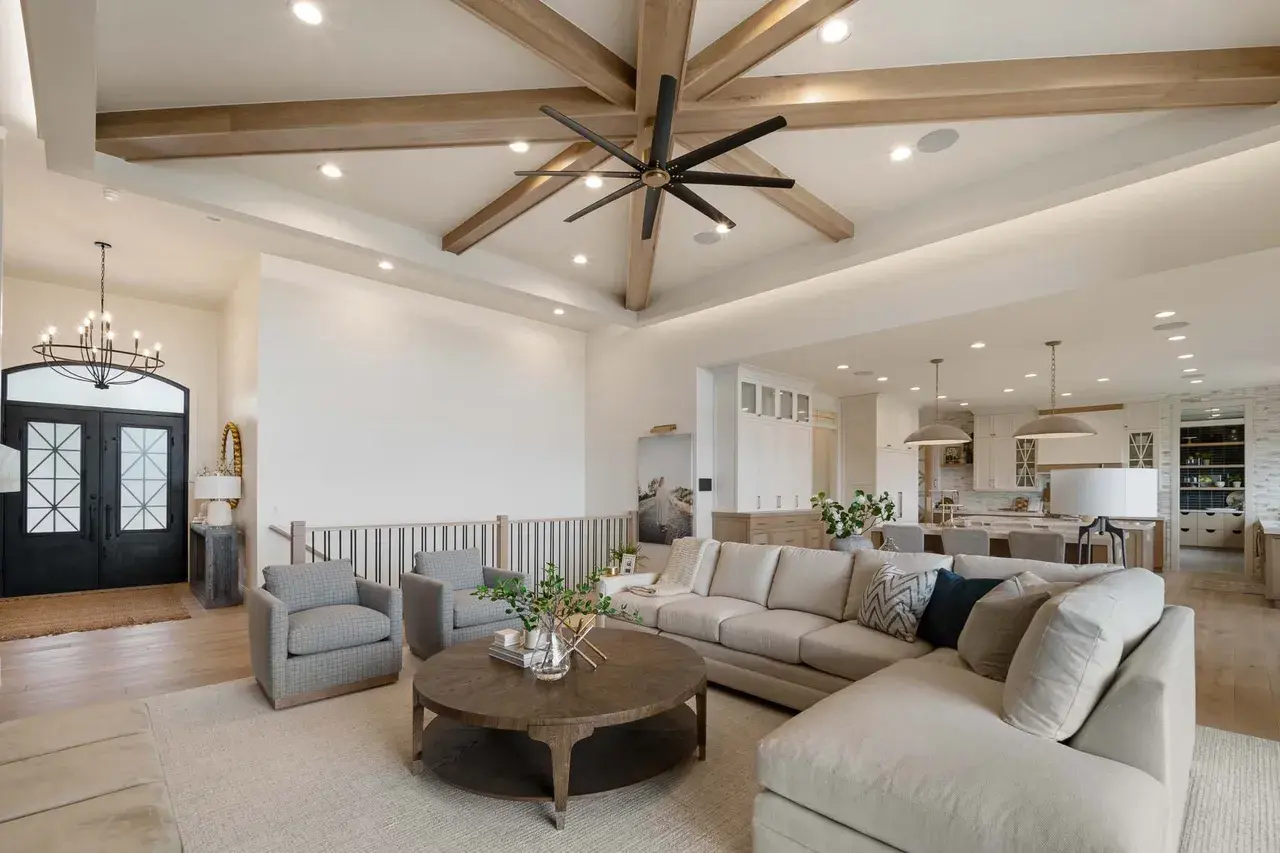 Vaulted ceiling and cozy sectional in a custom home in Utah Valley by E Builders