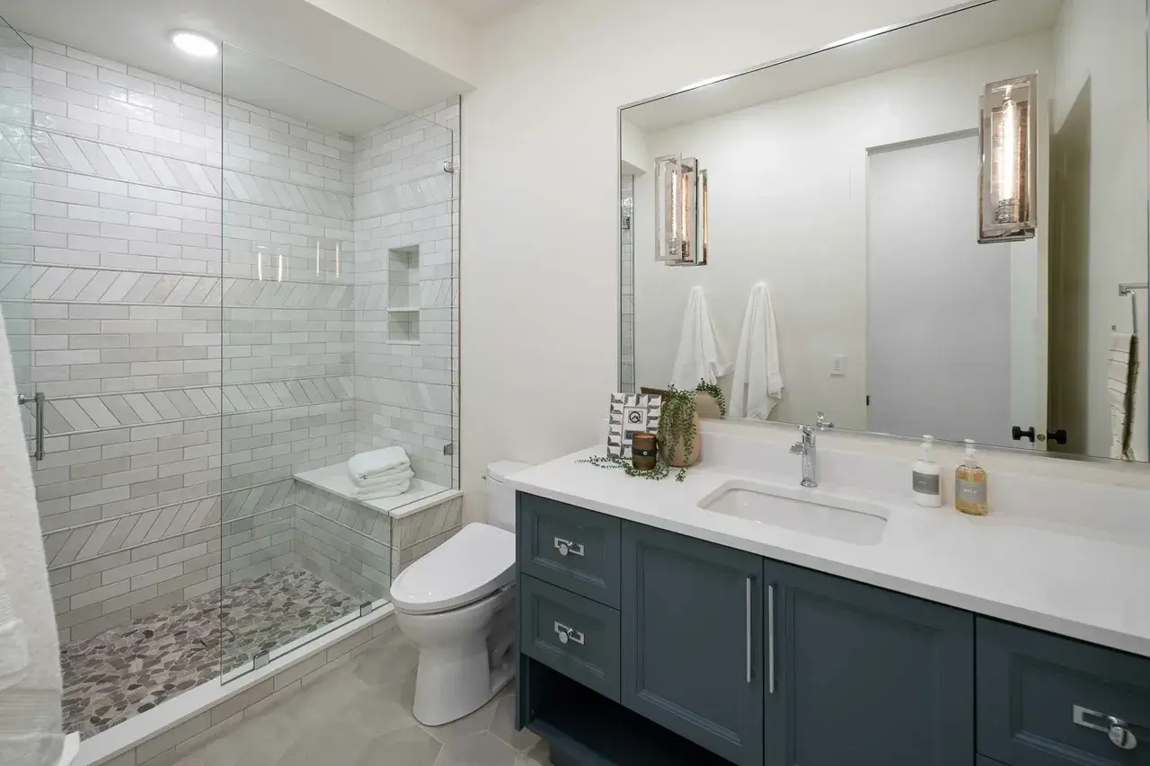 White subway tile shower and blue vanity in a custom home in Utah Valley by E Builders