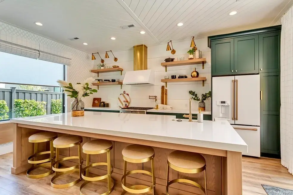 Contemporary kitchen design featuring gold hardware, an oversized island, and a stylish range hood in a custom home by E Builders, highlighted in the 2020 Utah Valley Parade of Homes