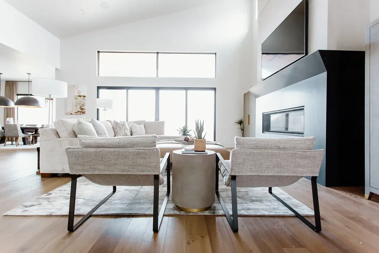Bright and open living room with a black fireplace and contemporary decor in a custom home by E Builders in Utah