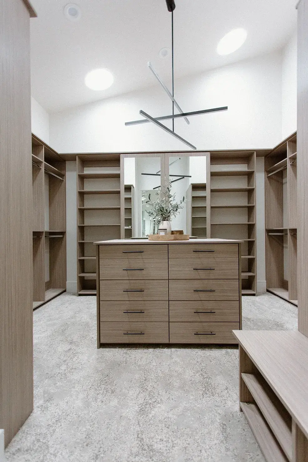 Elegant walk-in wardrobe with floor-to-ceiling shelving in a contemporary custom home in Utah by E Builders