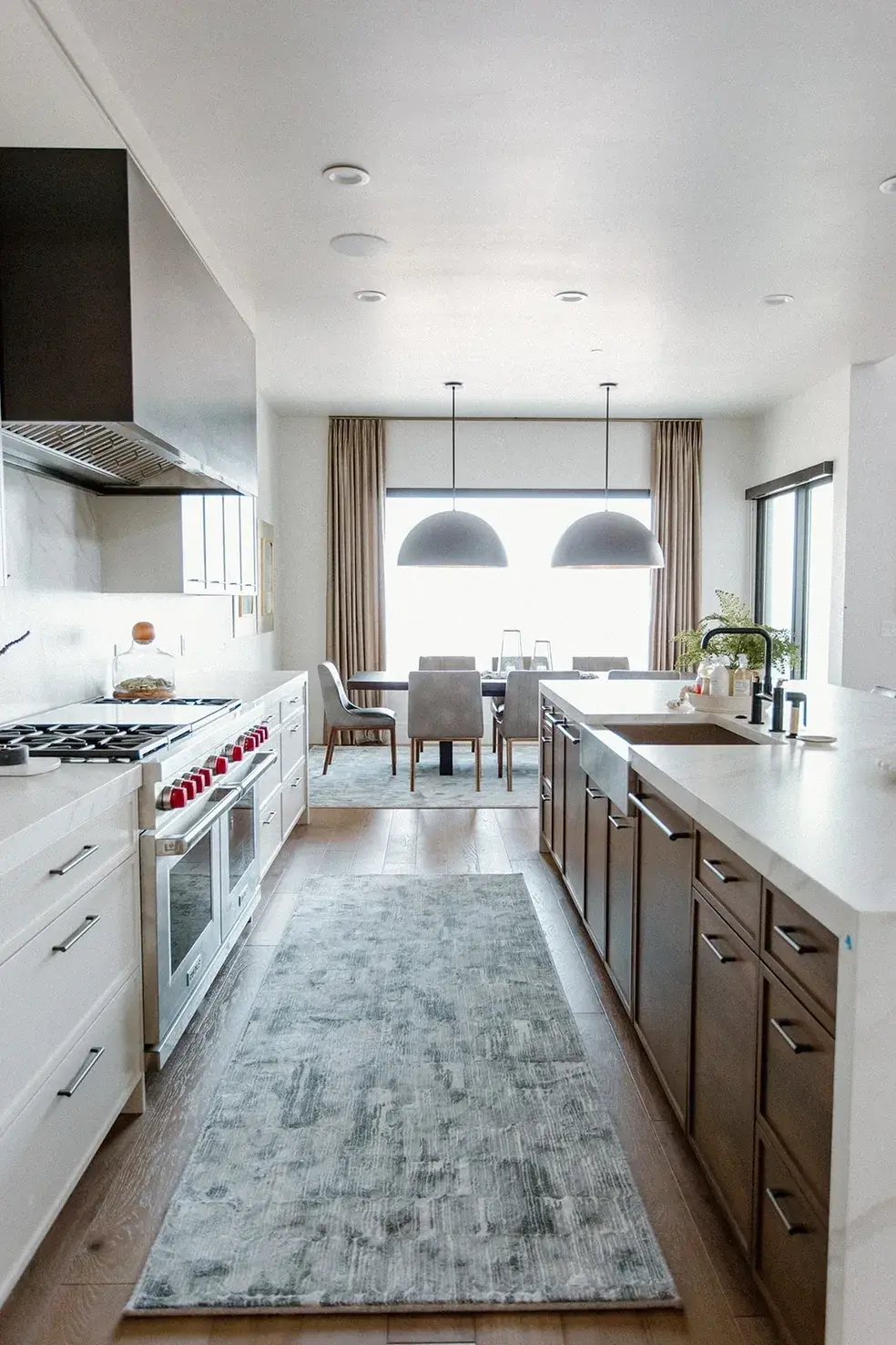 Luxury kitchen featuring custom cabinetry, high-end appliances, and a seamless dining area in a contemporary custom home in Utah by E Builders