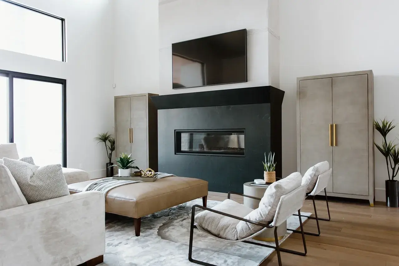 Open-concept living space with a statement fireplace and high ceilings in a contemporary custom home in Utah by E Builders