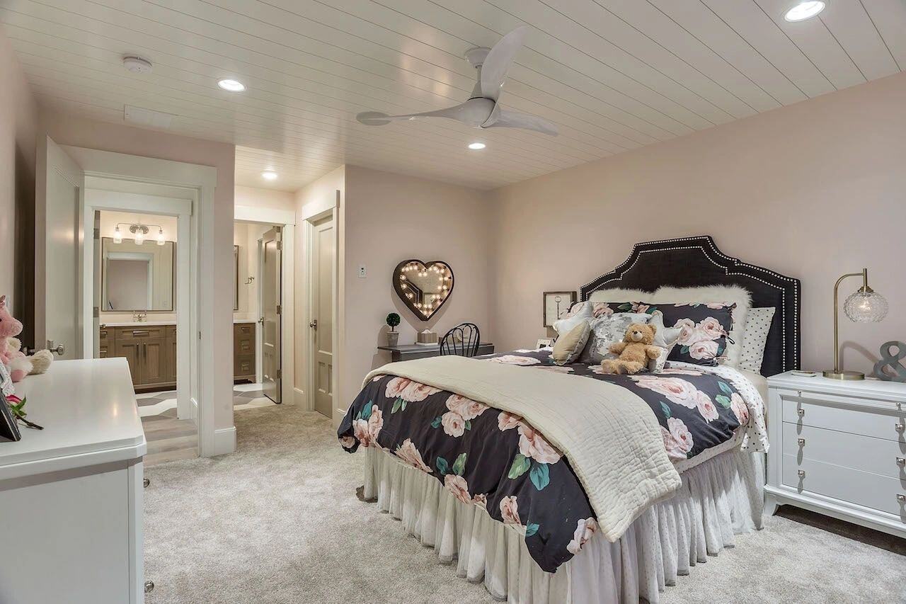 Feminine bedroom suite with attached bathroom in a custom home in Draper, UT by E Builders