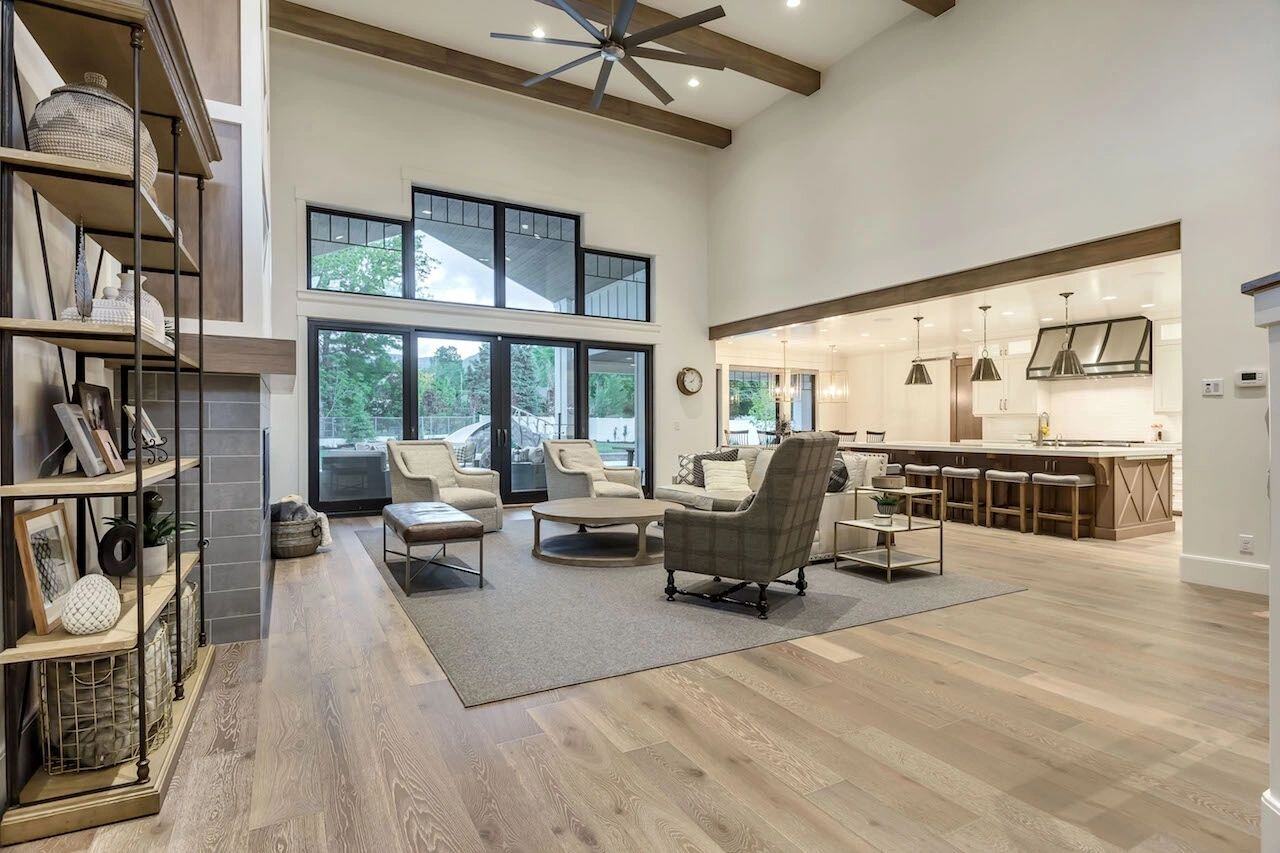 Great room with high ceilings and indoor-outdoor views in a custom home in Draper, UT by E Builders