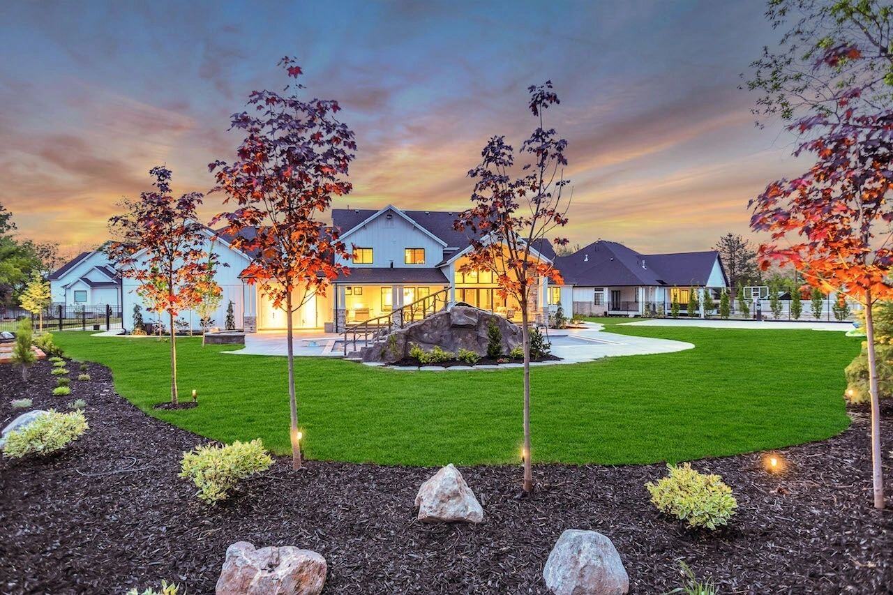 Scenic outdoor living area at dusk in a custom home in Draper, UT by E Builders