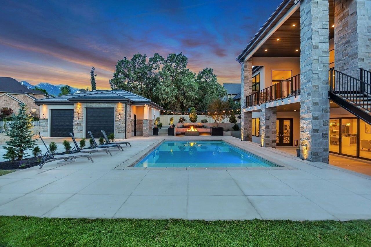 Poolside view at sunset outside of custom home in Utah by E Builders