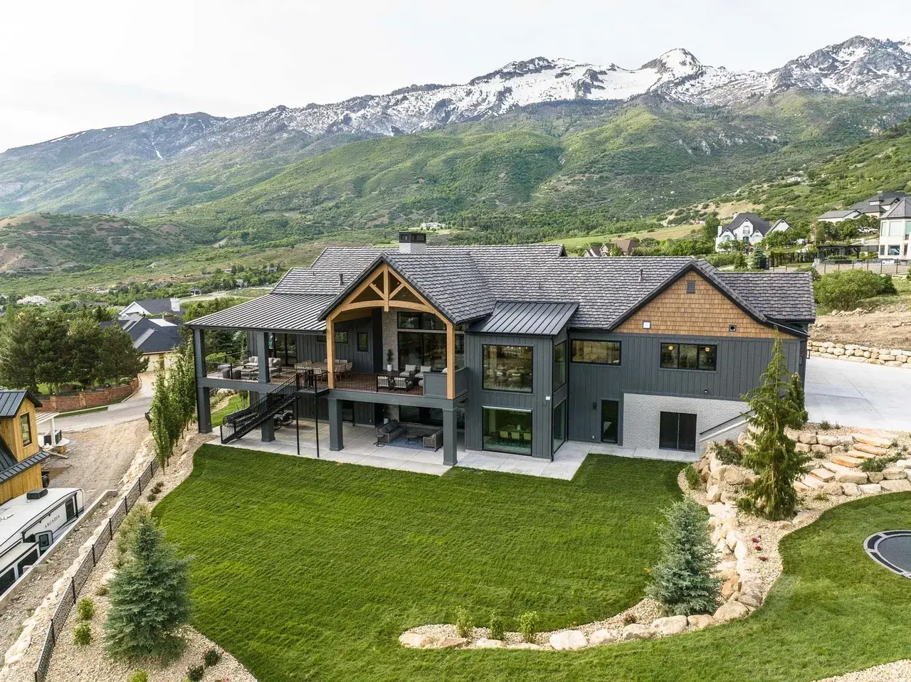 Rear exterior of custom home in Utah with balcony entertaining space by E Builders