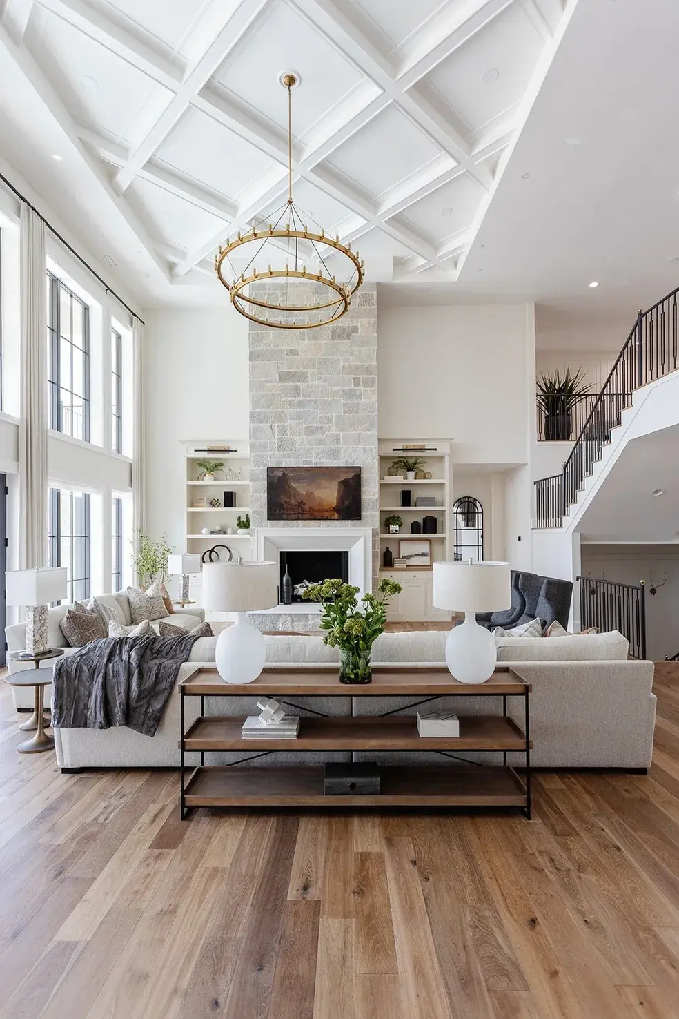 Custom living room featuring high ceilings and large chandelier by E Builders in Utah 