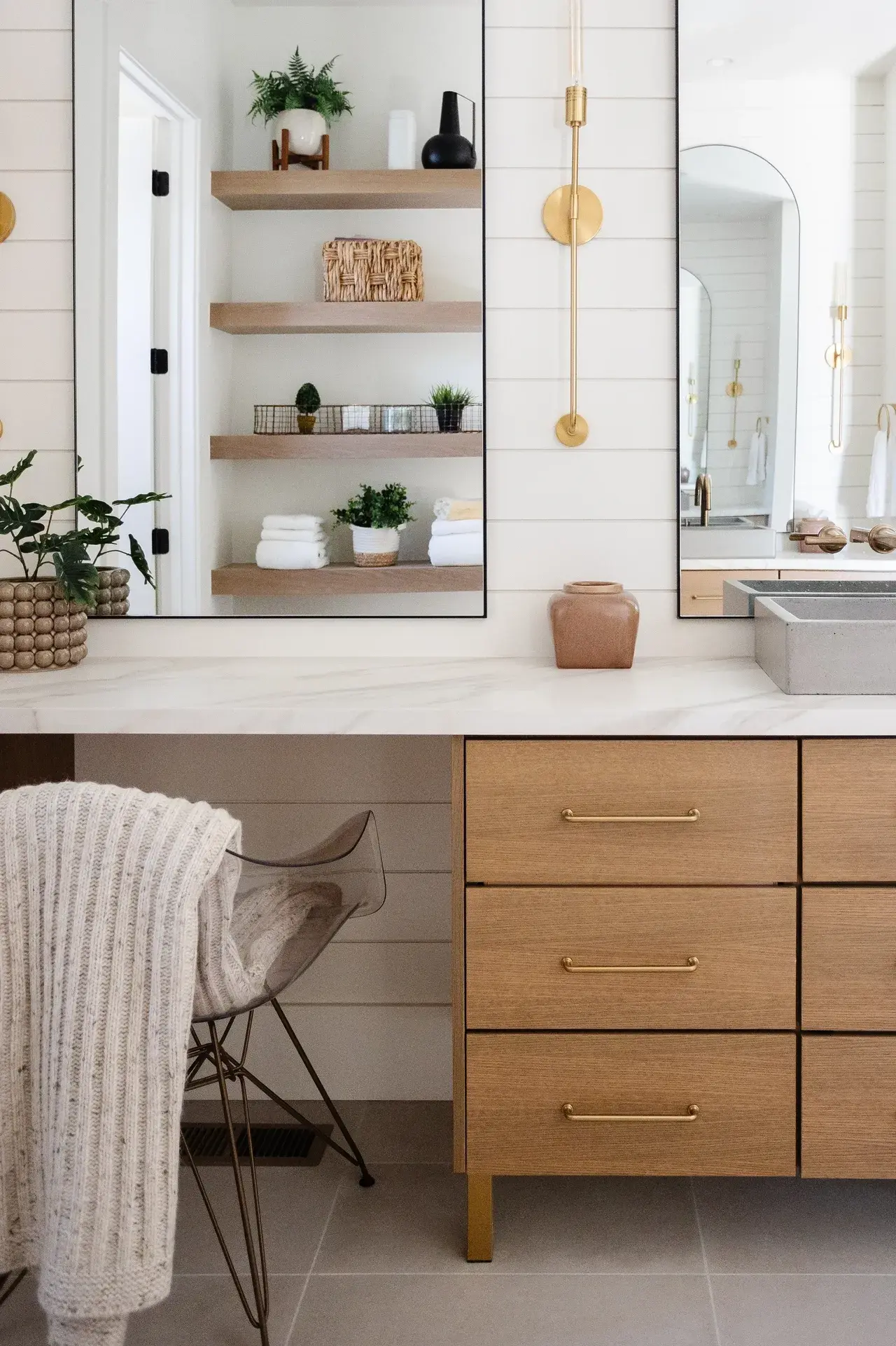Modern bathroom vanity with wood cabinetry, shiplap walls, and gold accents in a luxury custom home in Draper, Utah by E Builders
