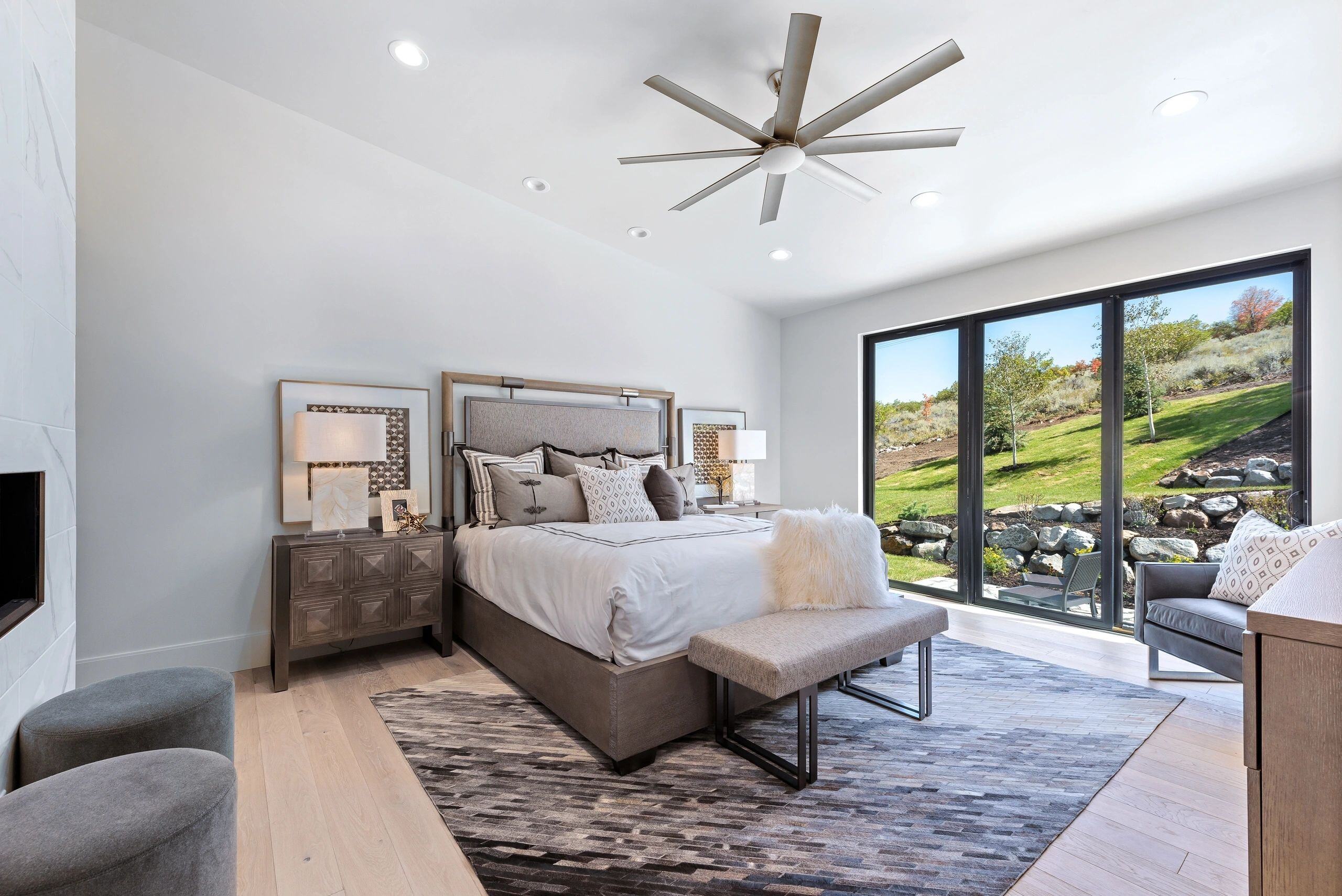 Master bedroom with modern design and natural light in a custom home in Park City, Utah by E Builders