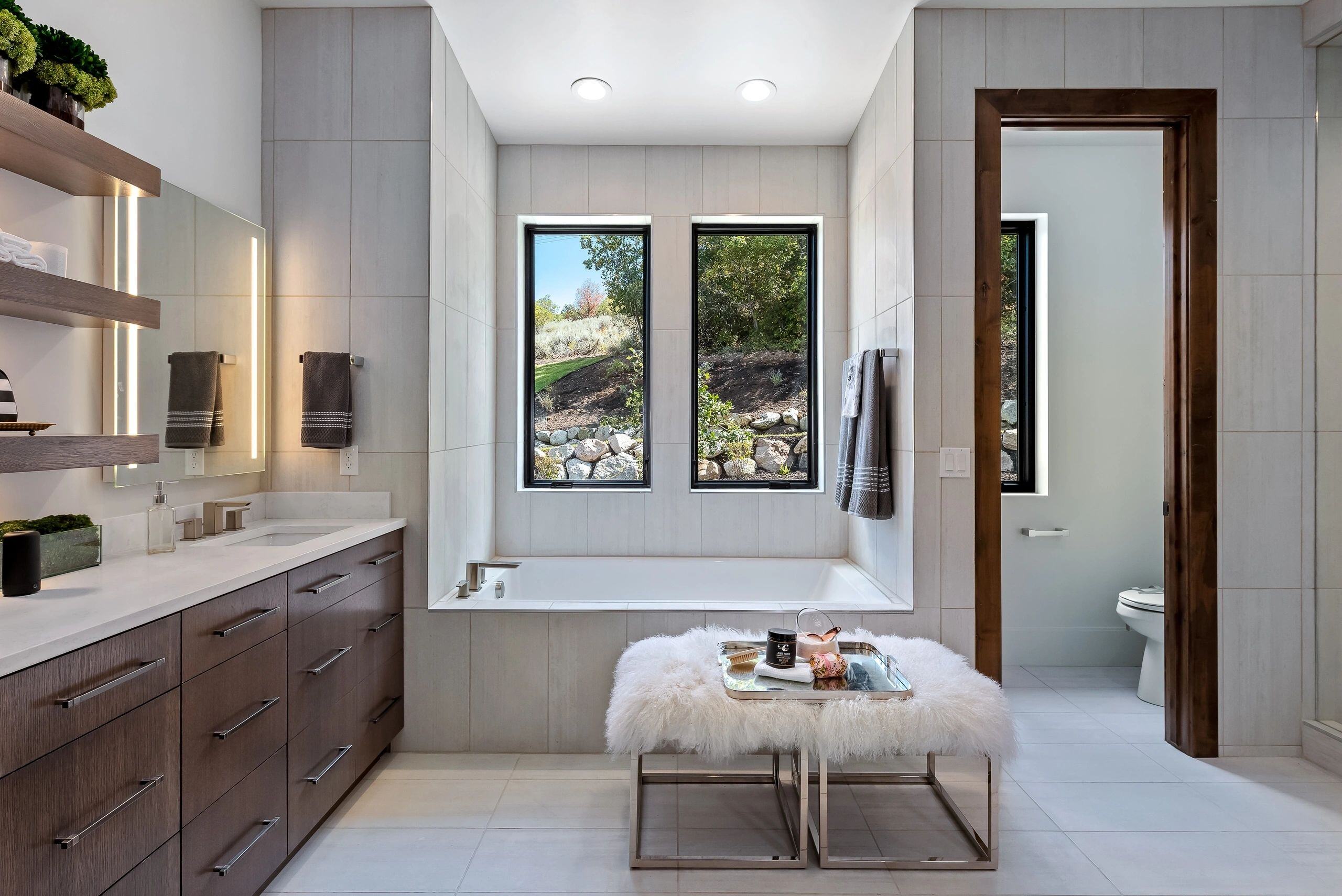 Relaxing master bath with natural light and scenic outdoor view in a custom home in Park City, Utah by E Builders