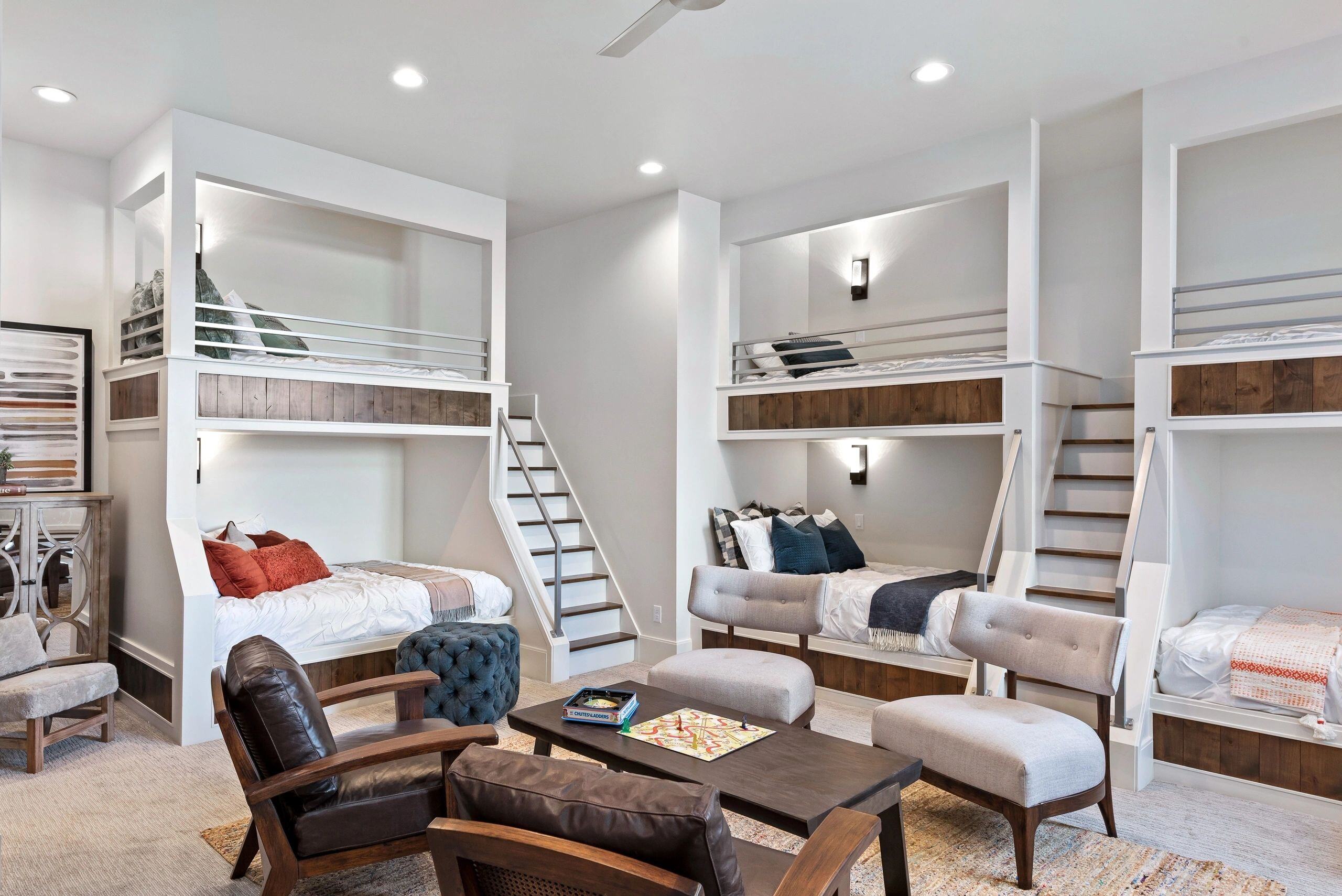 Spacious bunk room with four built-in beds and stairs in a custom home in Park City, Utah by E Builders