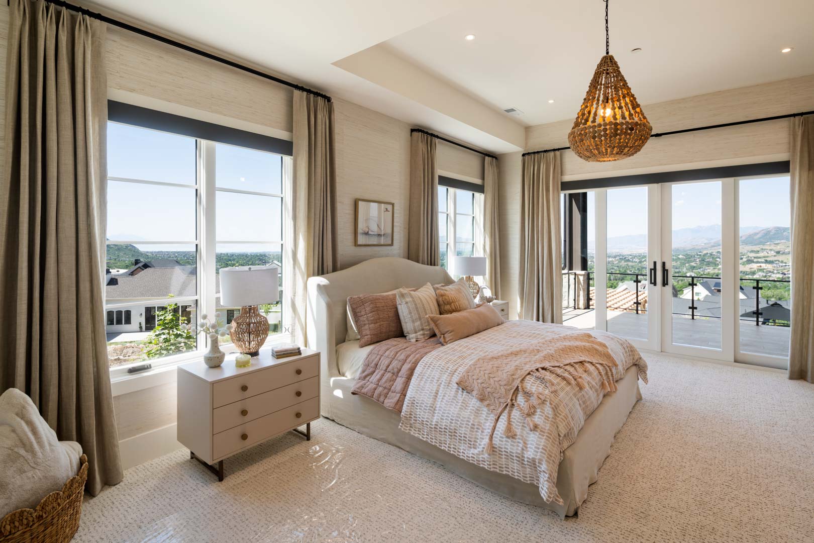 Bright bedroom with soft neutral tones and mountain views in custom home Room with a View featured in the 2025 Utah Valley Parade of Homes by E Builders