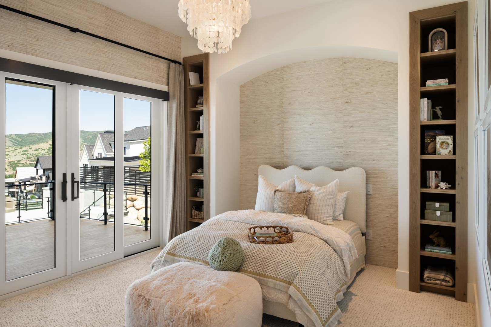 Cozy bedroom with arched headboard nook and neutral tones in custom home Room with a View featured in the 2025 Utah Valley Parade of Homes by E Builders