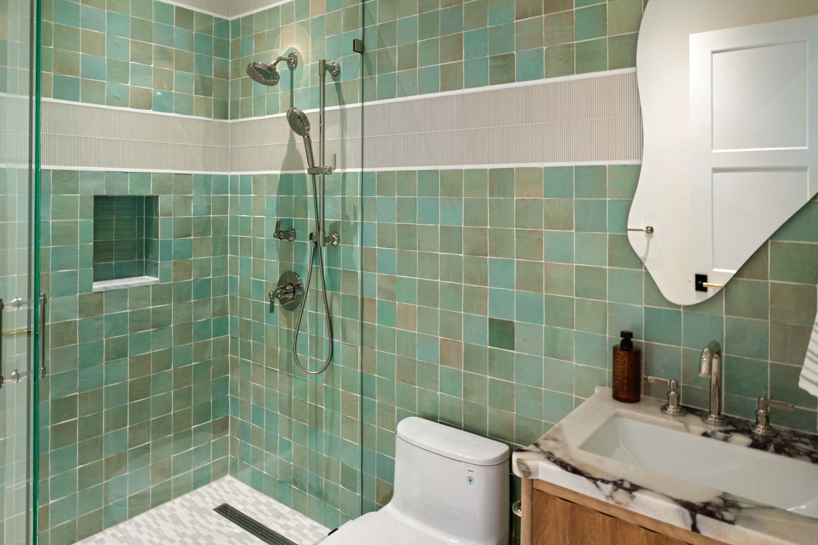 Guest bathroom with green tile shower and marble vanity in custom home Room with a View featured in the 2025 Utah Valley Parade of Homes by E Builders