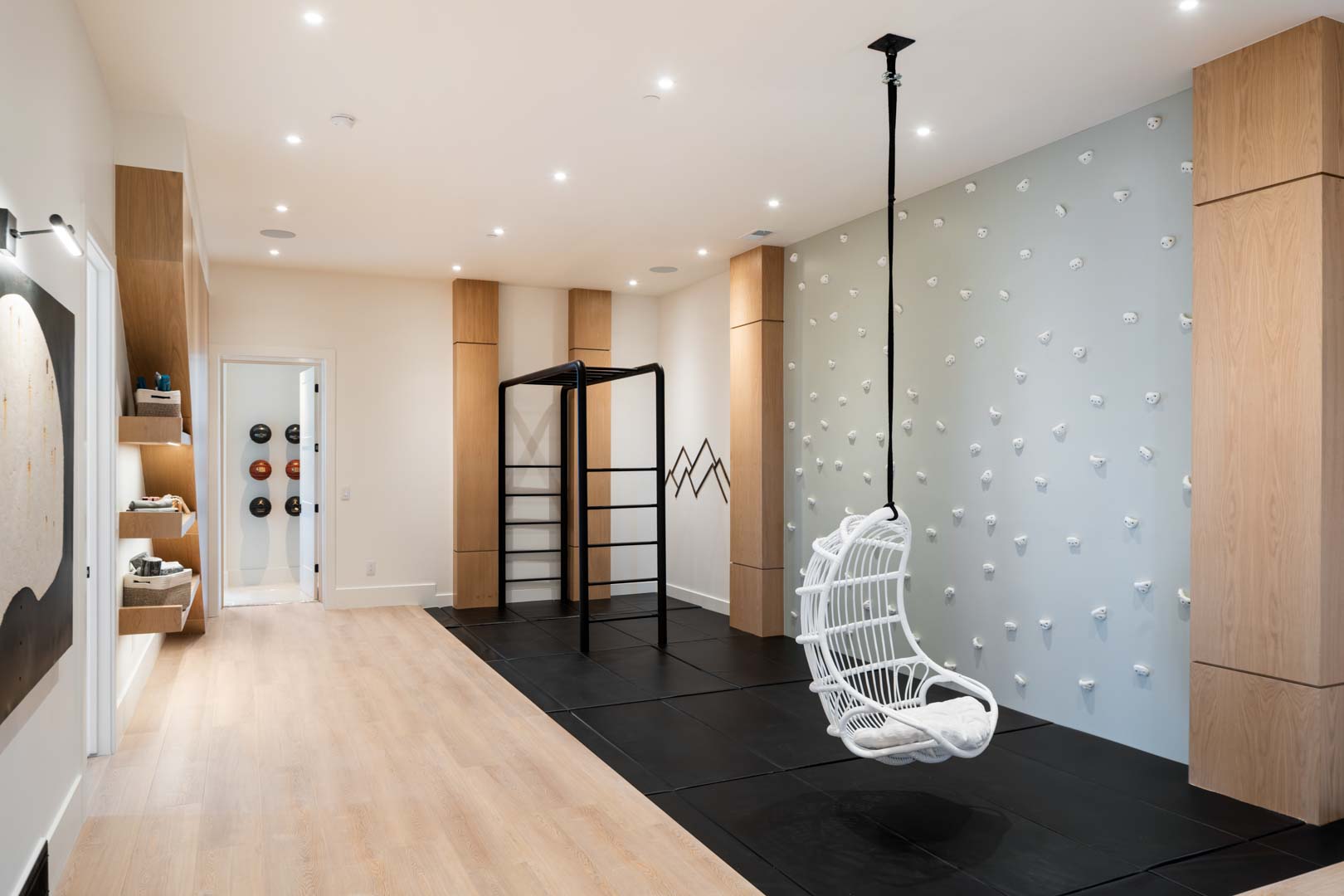 Indoor playroom with climbing wall and swing in custom home Room with a View featured in the 2025 Utah Valley Parade of Homes by E Builders