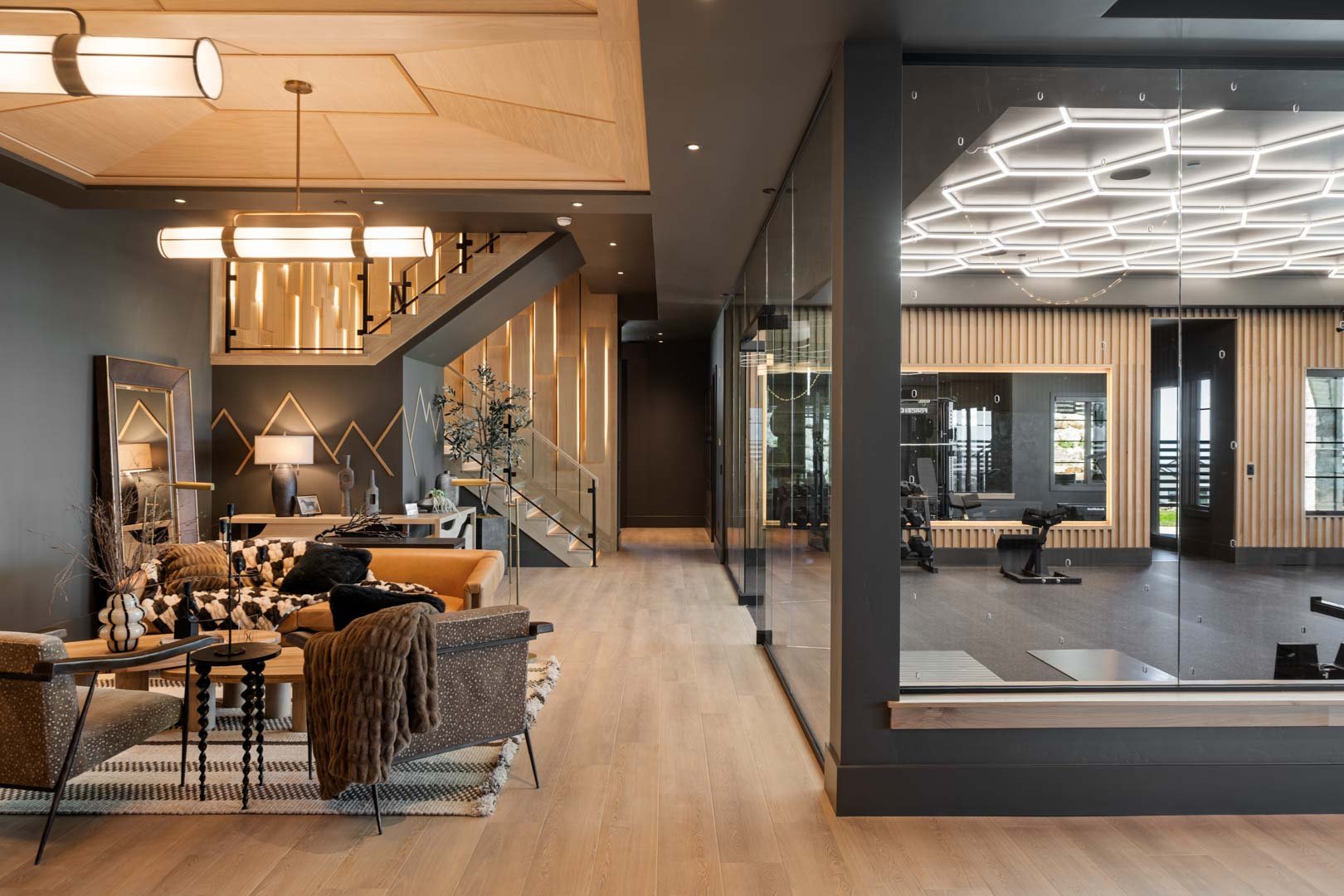 Modern basement lounge with open fitness studio in custom home Room with a View featured in the 2025 Utah Valley Parade of Homes by E Builders