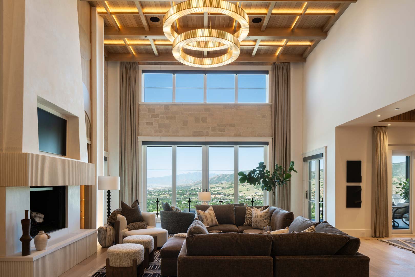 Mountain-facing great room filled with natural light in custom home Room with a View featured in the 2025 Utah Valley Parade of Homes by E Builders