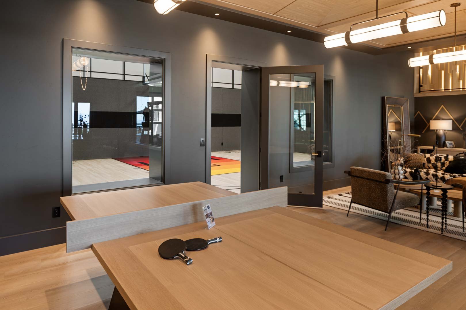 Ping pong table near indoor court in custom home Room with a View featured in the 2025 Utah Valley Parade of Homes by E Builders
