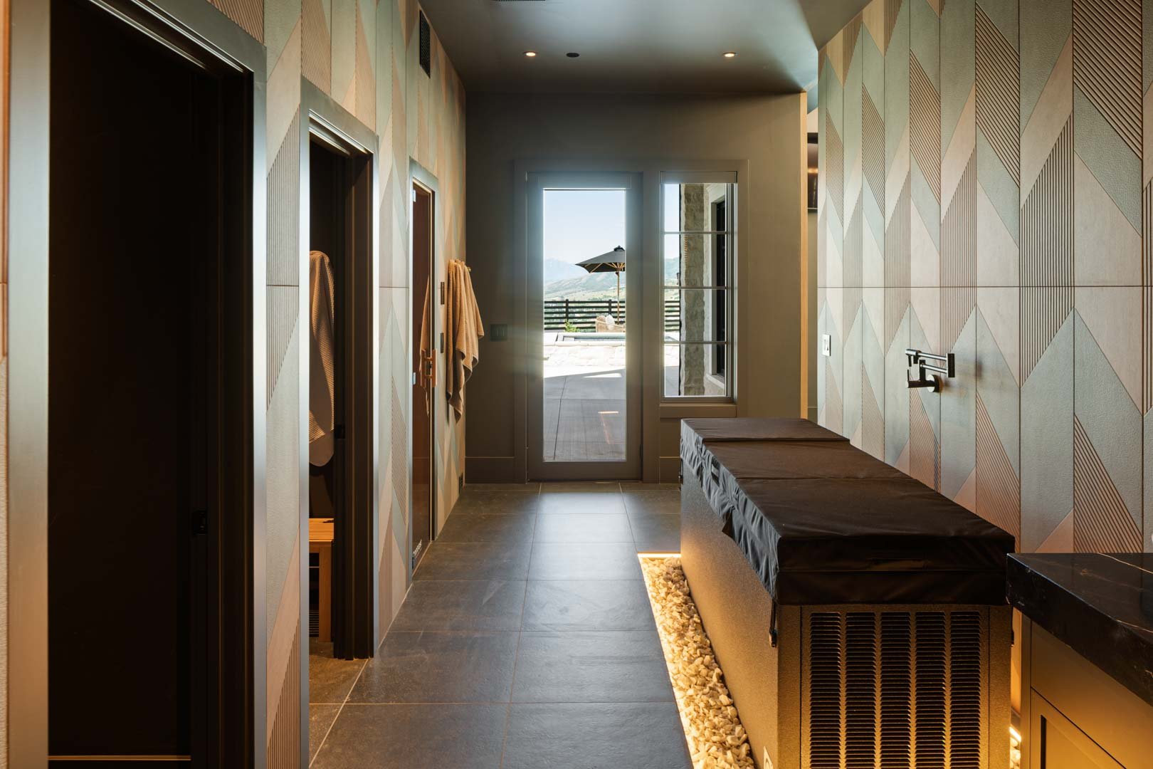Serene corridor leading to outdoor amenities in custom home Room with a View featured in the 2025 Utah Valley Parade of Homes by E Builders