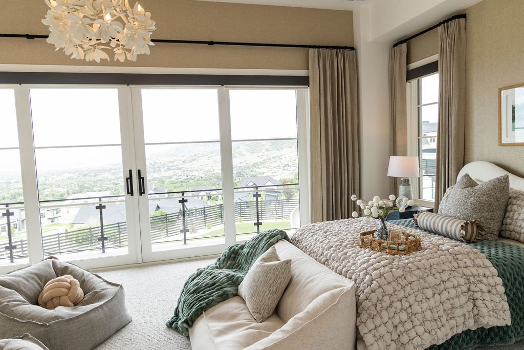 Serene primary bedroom with panoramic mountain views through sliding glass doors in the Room with a View custom home featured in the 2025 Utah Valley Parade of Homes by E Builders