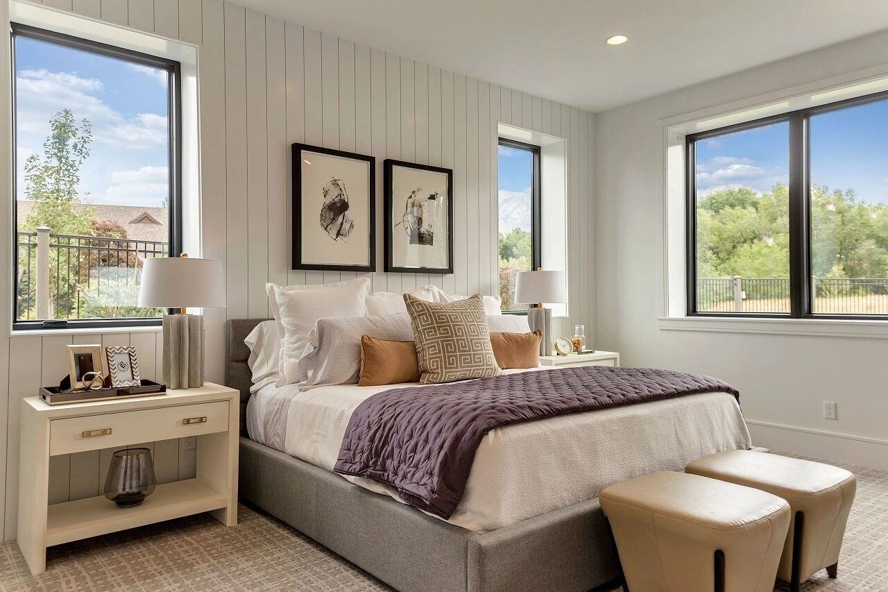Bright and cozy guest bedroom with mountain views in a custom home in Salt Lake City, UT built by E Builders