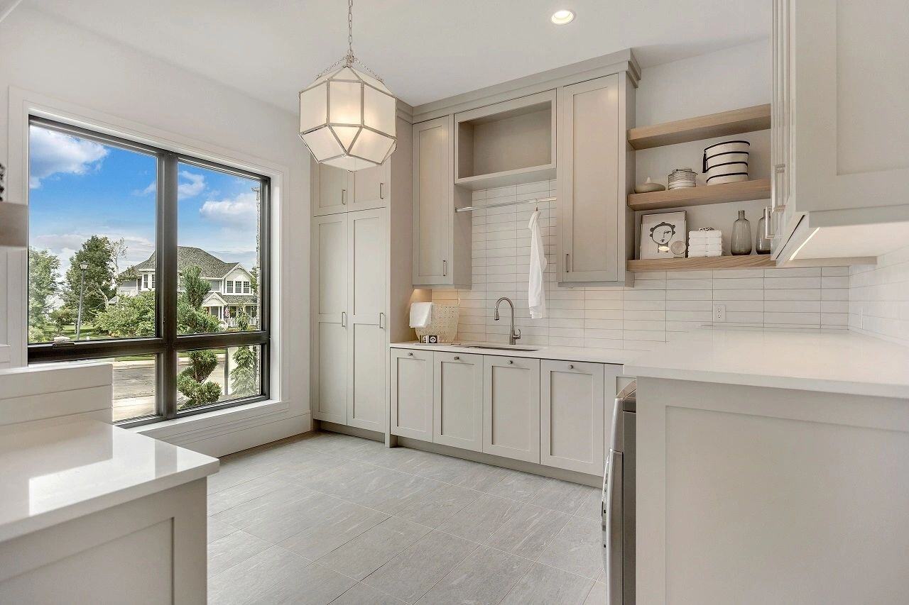 Elegant bar and kitchenette area with seating in a custom home in Salt Lake City, UT built by E Builders.