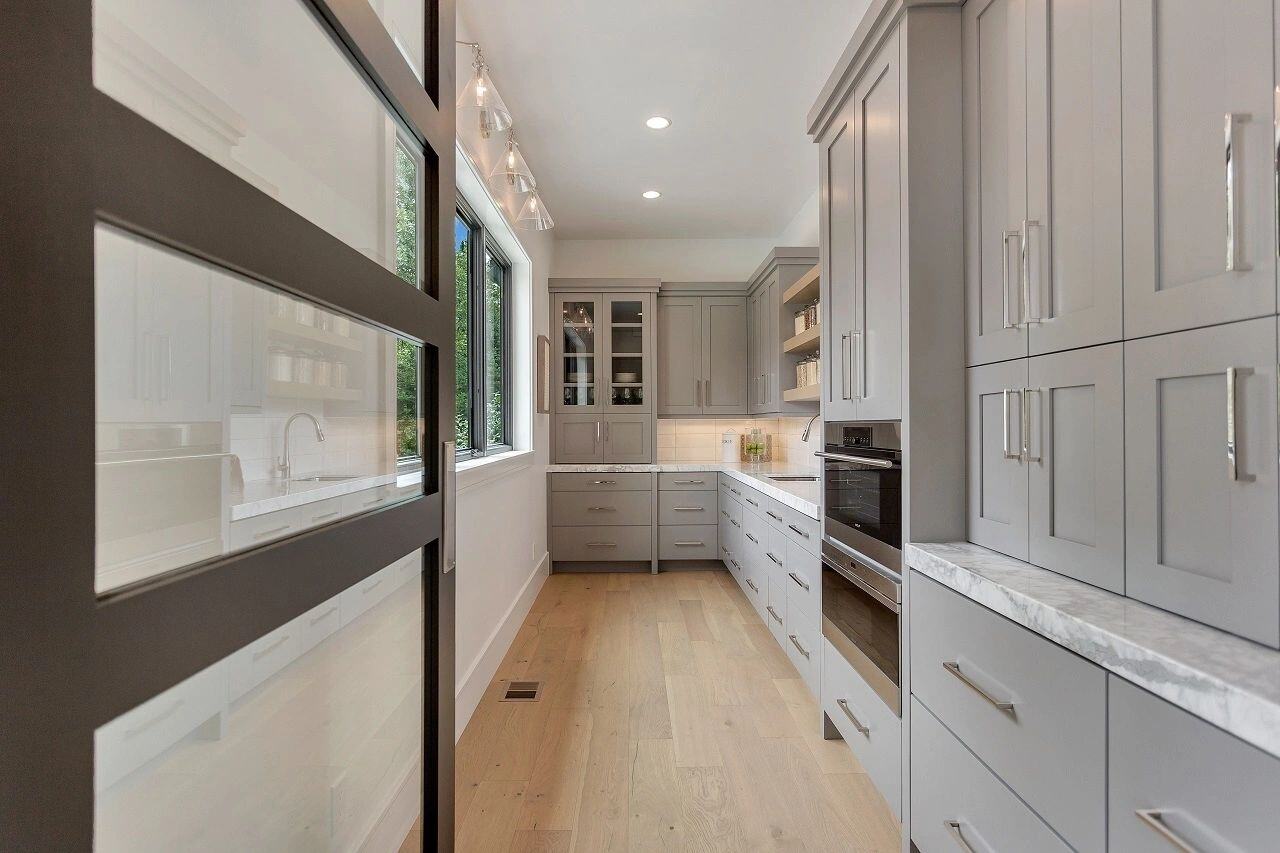 Modern butler's pantry featuring soft gray finishes in a custom home in Salt Lake City, UT built by E Builders