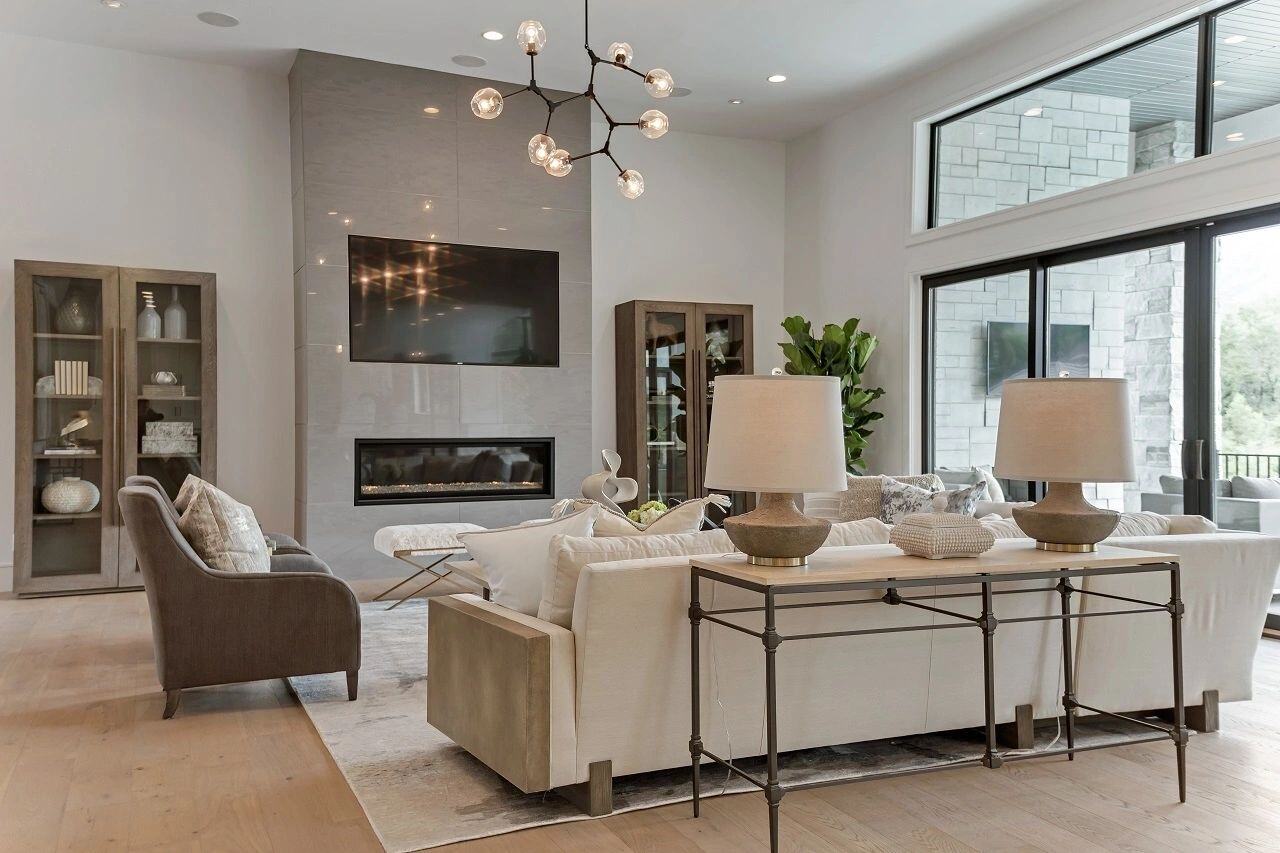 Modern living area with neutral tones and designer lighting in a custom home in Salt Lake City, UT built by E Builders