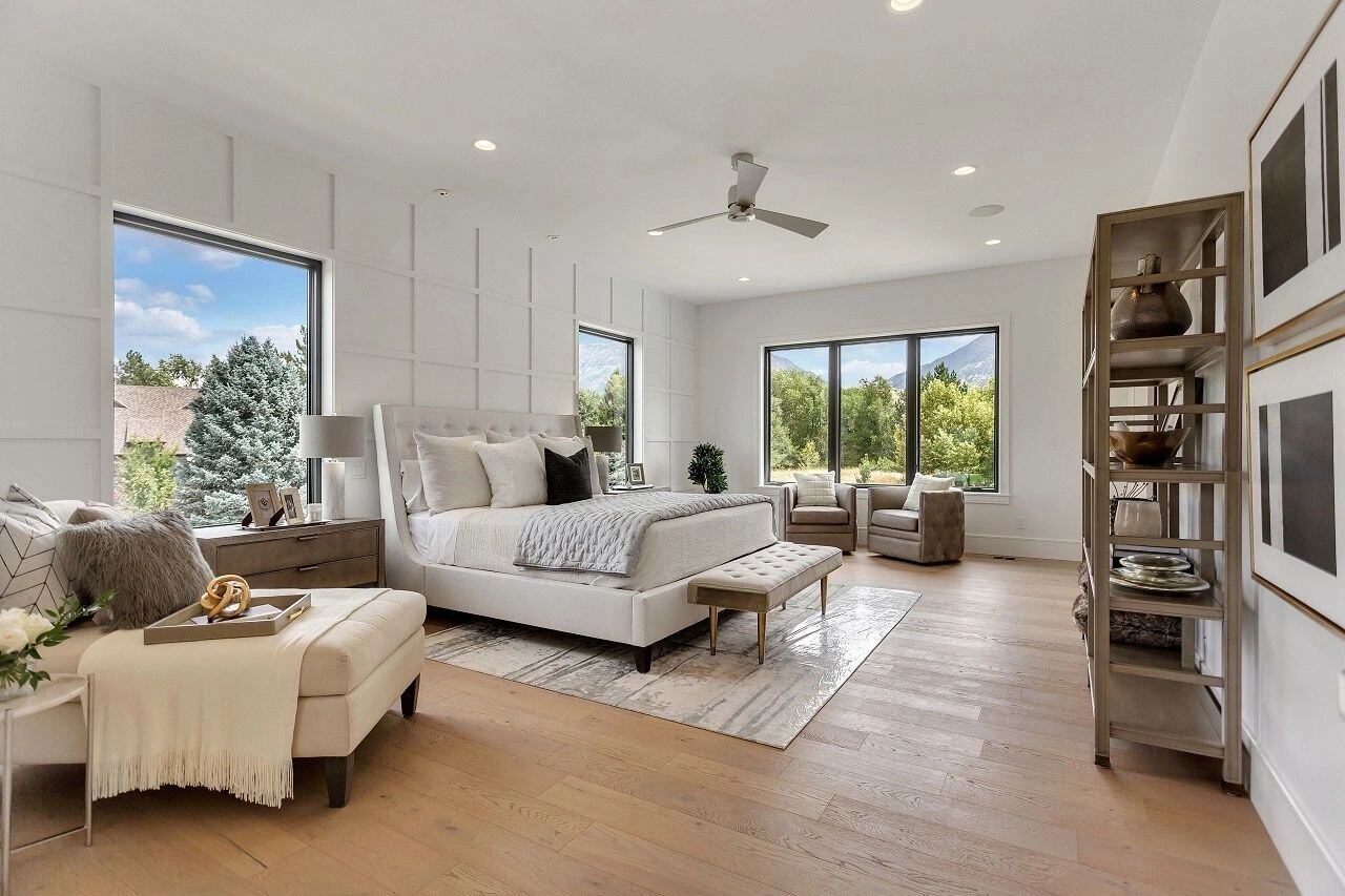 Spacious master bedroom with seating area and mountain views in a custom home in Salt Lake City, UT built by E Builders