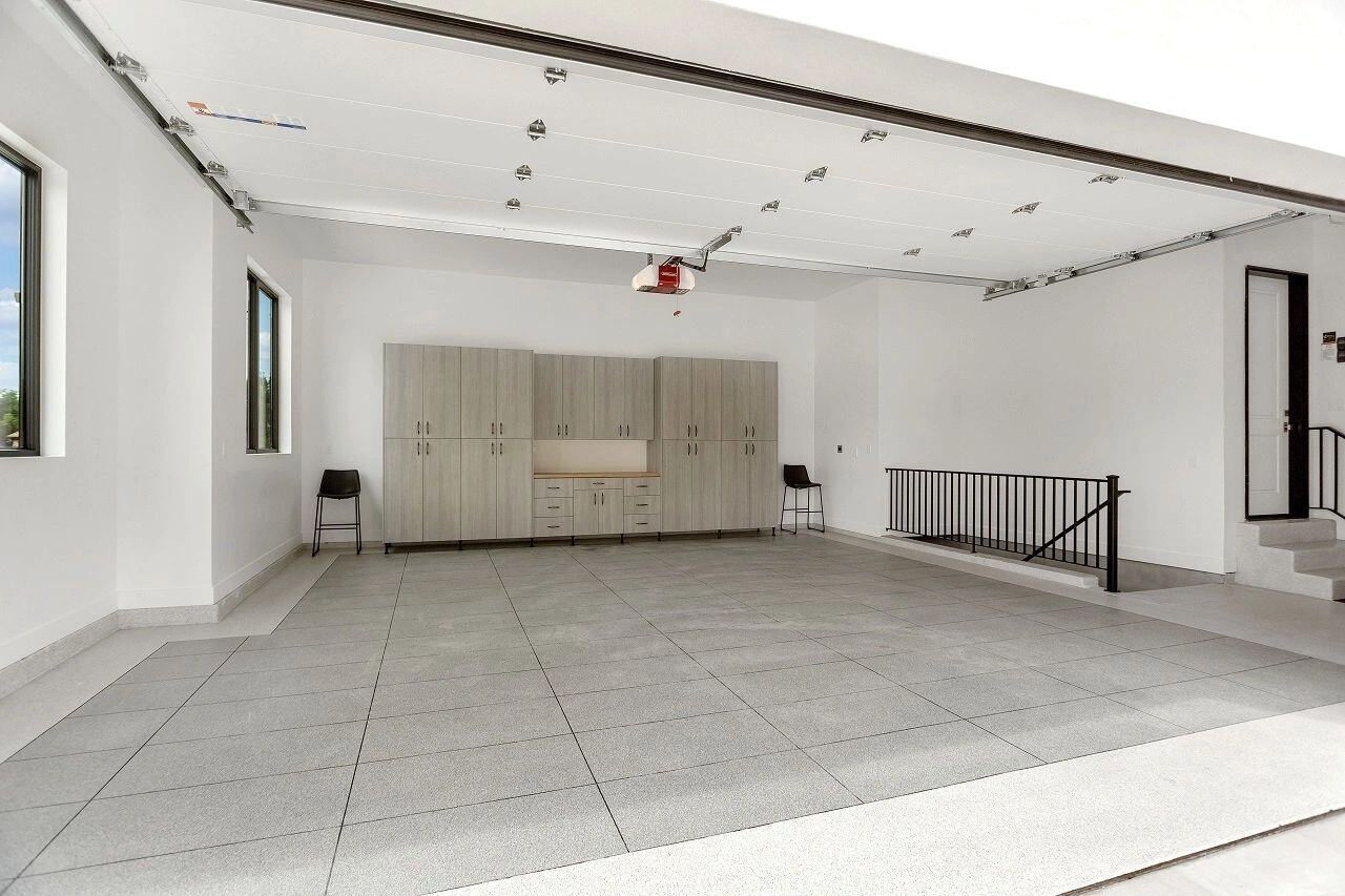 Spacious three-car garage with built-in cabinetry in a custom home in Salt Lake City, UT built by E Builders
