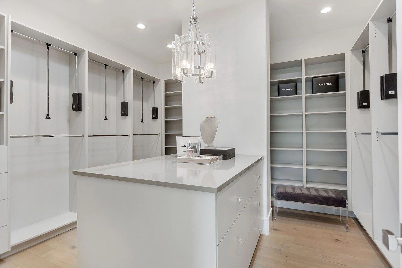 Spacious walk-in closet with center island and custom shelving in a custom home in Salt Lake City, UT built by E Builders