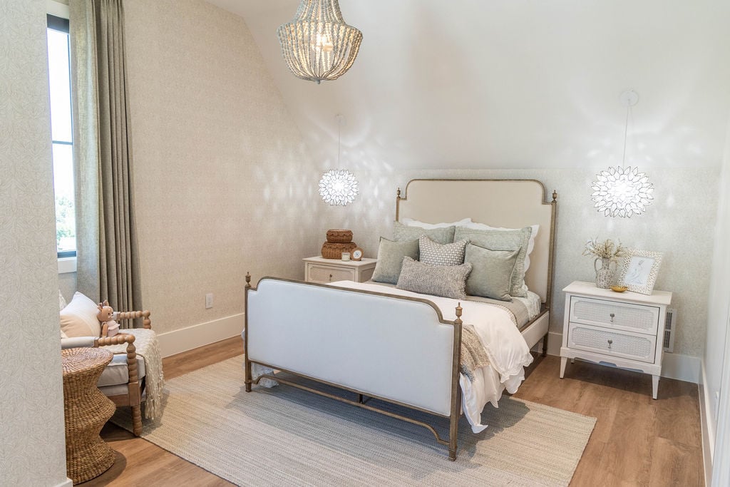 Bright bedroom with elegant white and sage bedding in a custom home featured in the 2025 Utah Valley Parade of Homes
