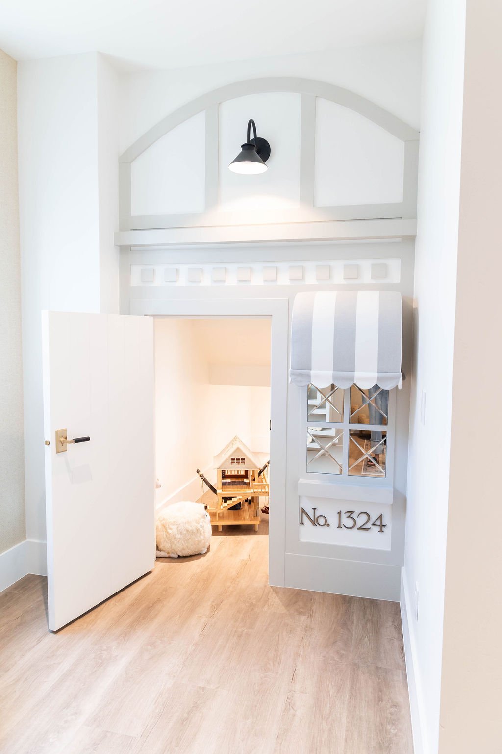 Built-in children’s playroom with faux exterior window and light fixture in a custom home featured in the 2025 Utah Valley Parade of Homes