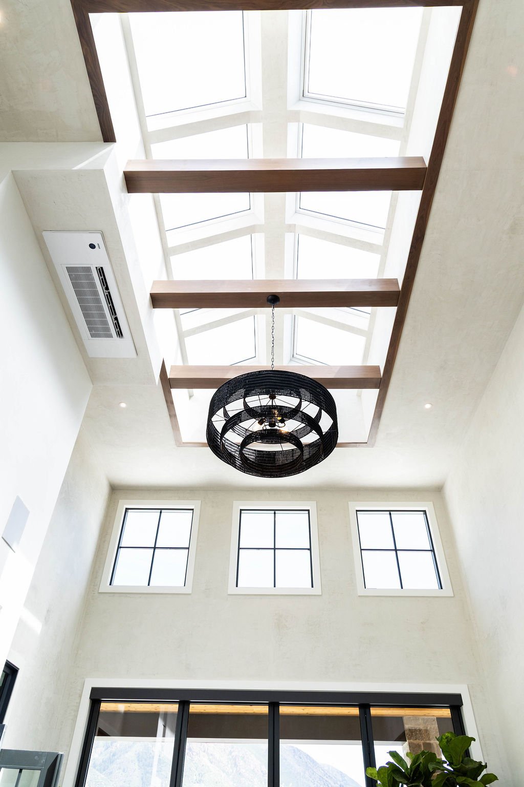 Courtyard vaulted ceiling with skylights and wood beams in custom home featured in the 2025 Utah Valley Parade of Homes by E Builders