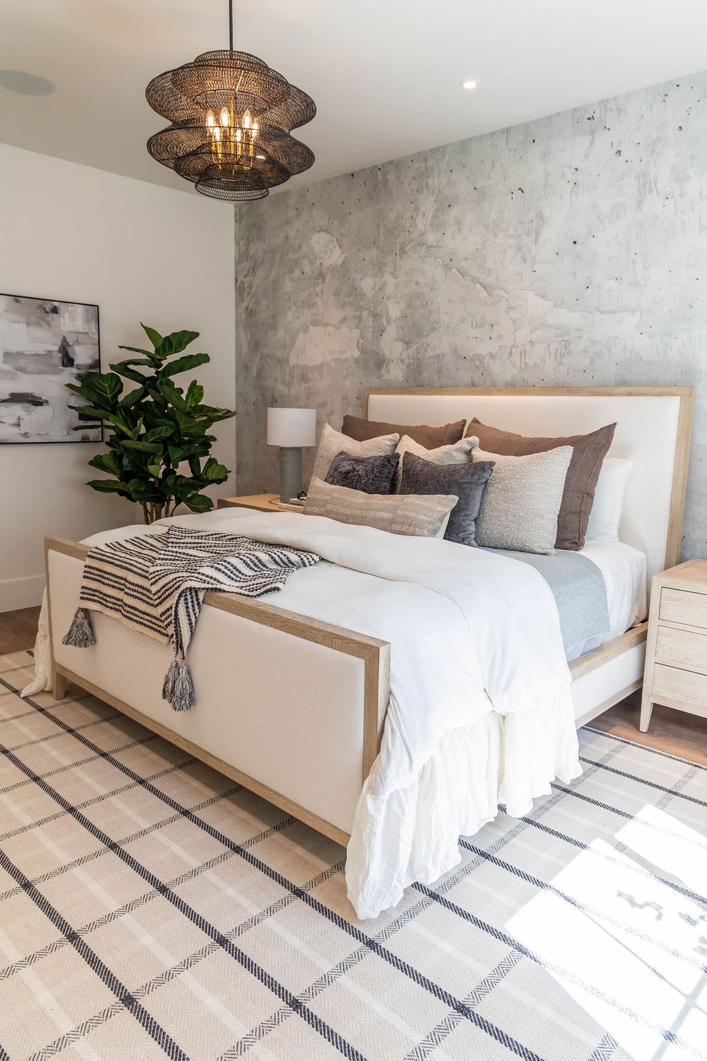 Cozy bedroom with accent wall and layered bedding in E Builders’ 2025 Parade Home in Utah