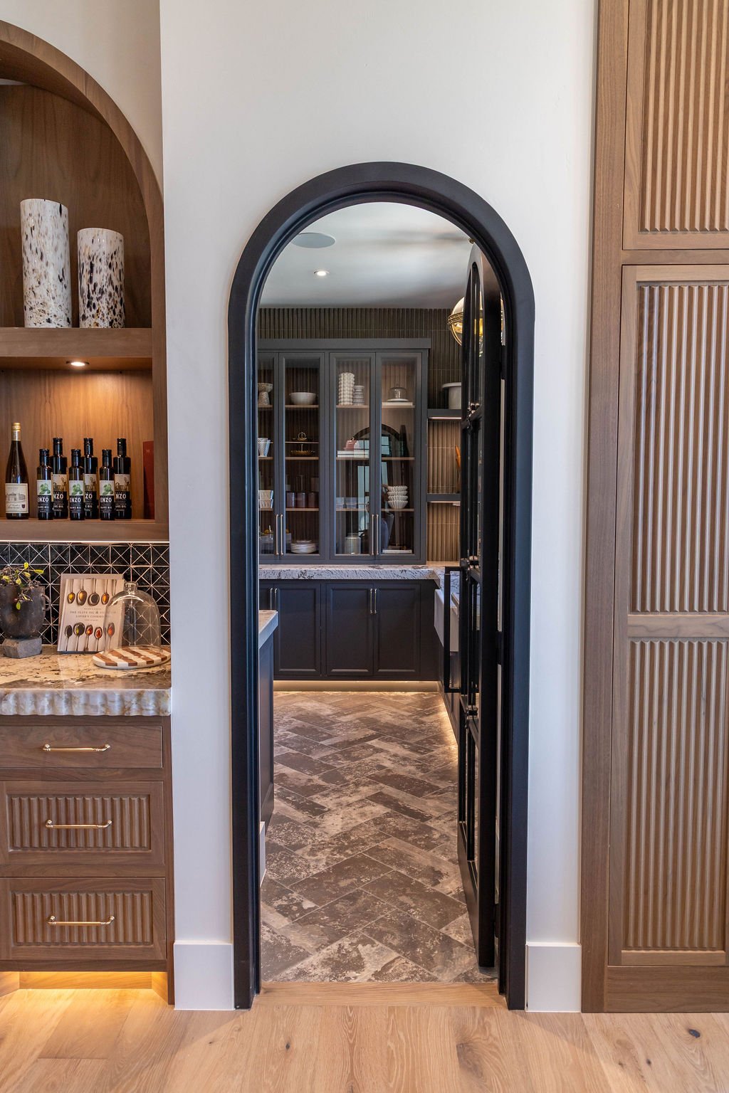 Custom pantry with Francini Aspen Polish countertop and herringbone tile flooring in a custom home featured in the 2025 Utah Valley Parade of Homes